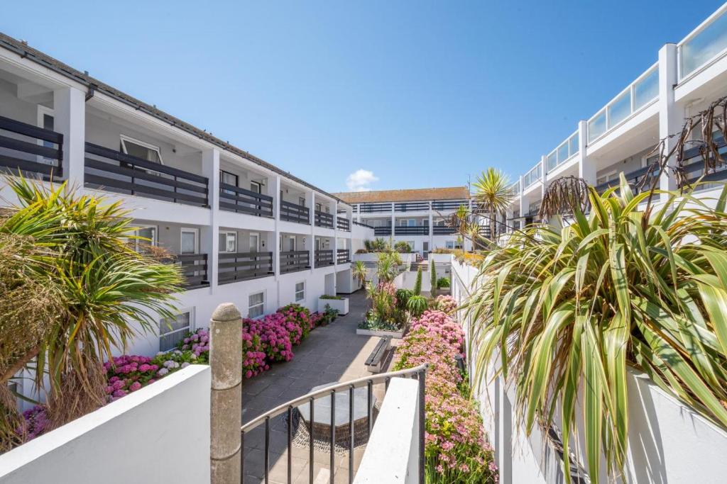 a balcony view of a building with palm trees and flowers at 2 Bed in St. Ives oc-18stn in St Ives