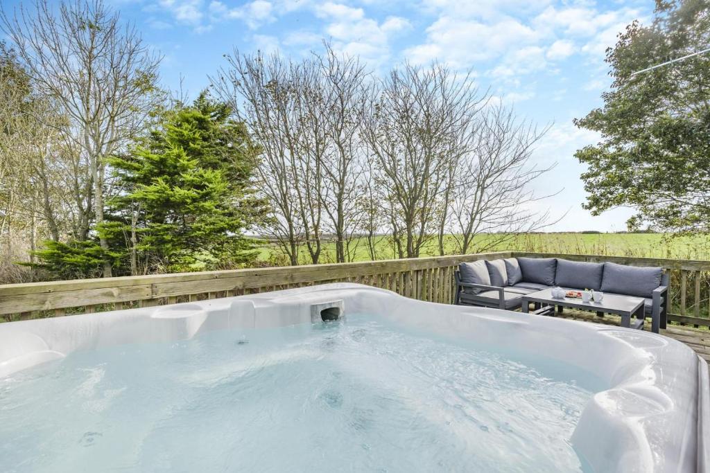 a bath tub sitting on a fence with a chair at 3 Bed in St. Merryn oc-k30138 in Saint Merryn