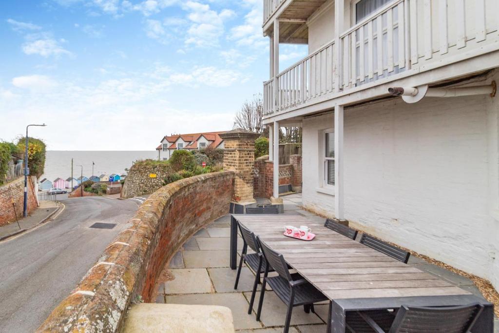 a wooden bench sitting on the side of a building at 2 Bed in Felixstowe oc-m30281 in Felixstowe