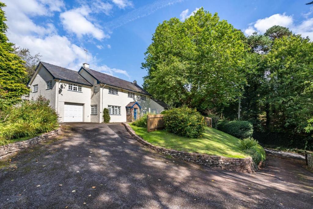 a large white house with a driveway at 3 Bed in Scethrog oc-h30013 in Scethrog