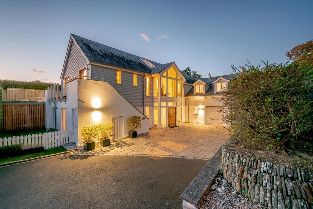 a large house with a driveway in front of it at 5 Bed in Rock oc-m33185 in Roche