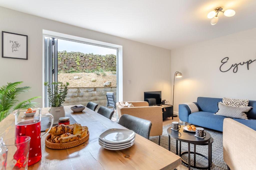 a living room with a table and a blue couch at 3 Bed in Middlesmoor oc-w30366 in Middlesmoor