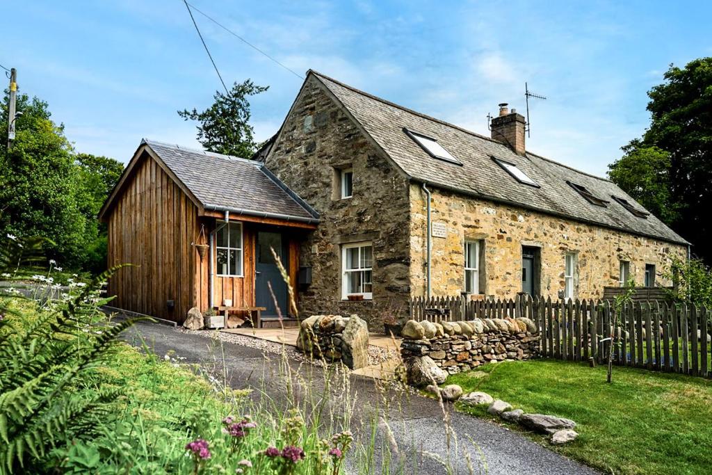 an old stone house with a wooden fence at 2 Bed in Dunkeld oc-i30992 in Dunkeld