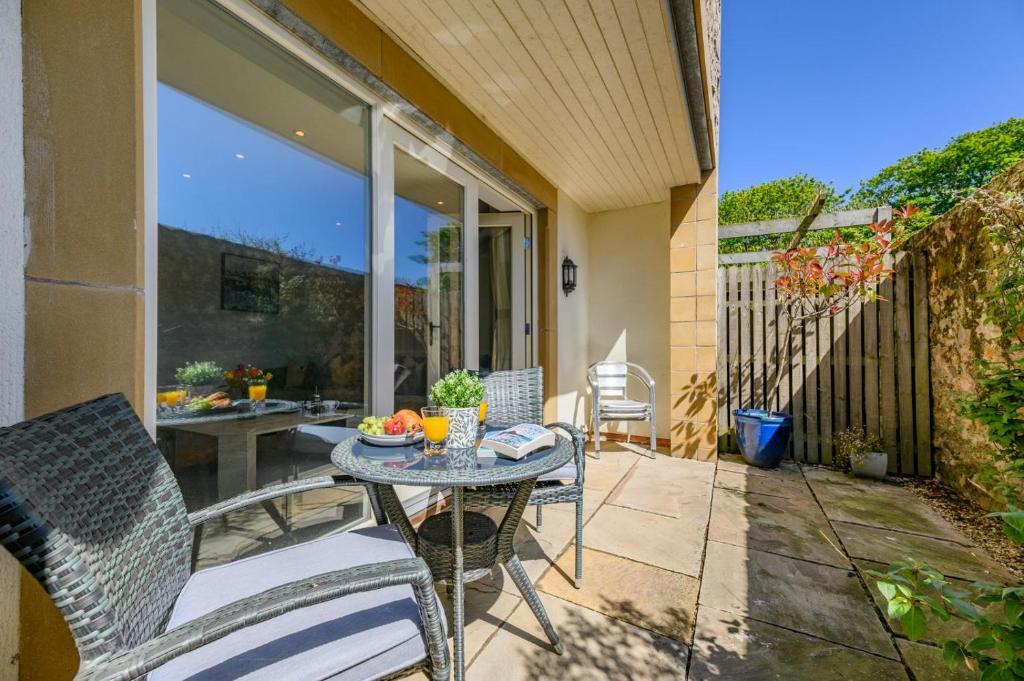 a patio with a table and chairs on a porch at 2 Bed in Beadnell oc-s30910 in Beadnell