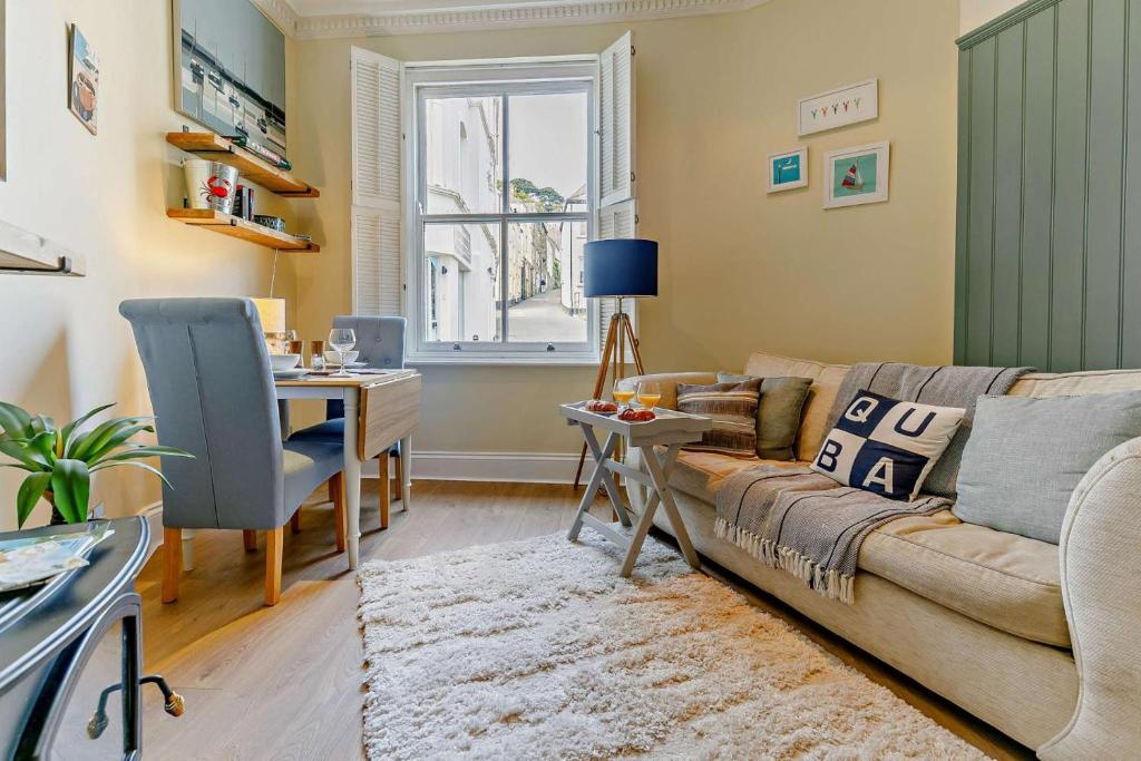 a living room with a couch and a table at 1 Bed in Fowey oc-m27634 in Fowey