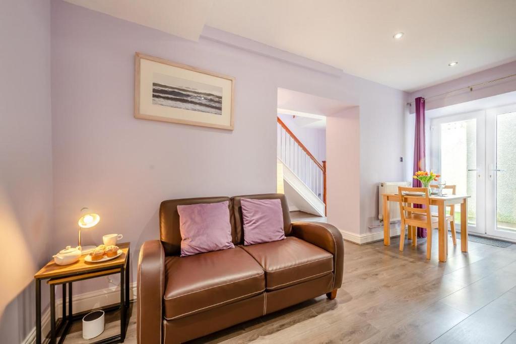 a living room with a couch and a table at 1 Bed in Tenby oc-w28986 in Tenby
