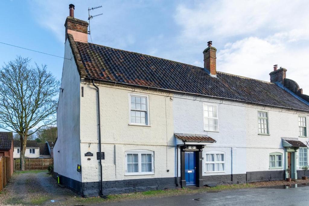 an old white house with a blue door at 2 Bed in Buxton oc-b30030 in Buxton