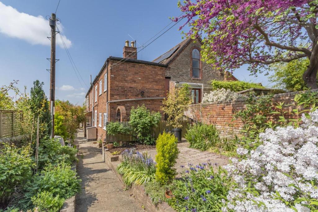an old brick house with a garden in front of it at 3 Bed in Ledbury oc-s32045 in Ledbury