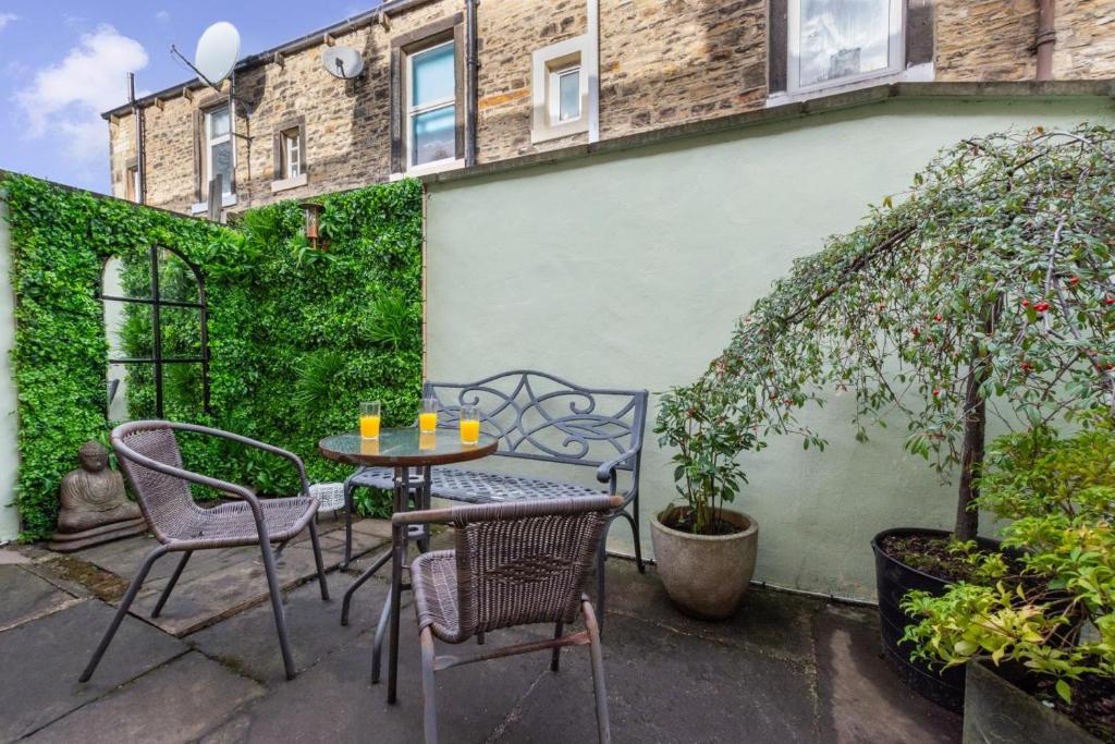 a patio with a table and chairs in front of a building at 2 Bed in Skipton oc-ds932 in Skipton