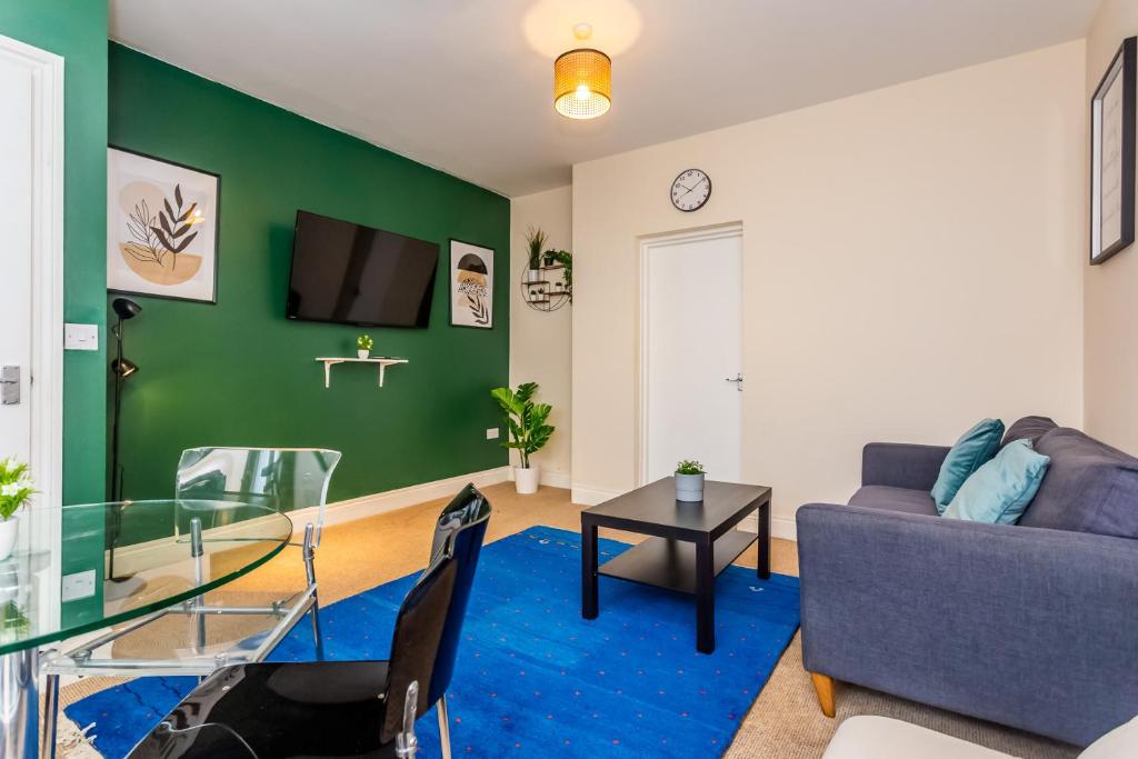 a living room with a couch and a glass table at Two Bed Apartment RYTON With Free Parking in Ryton