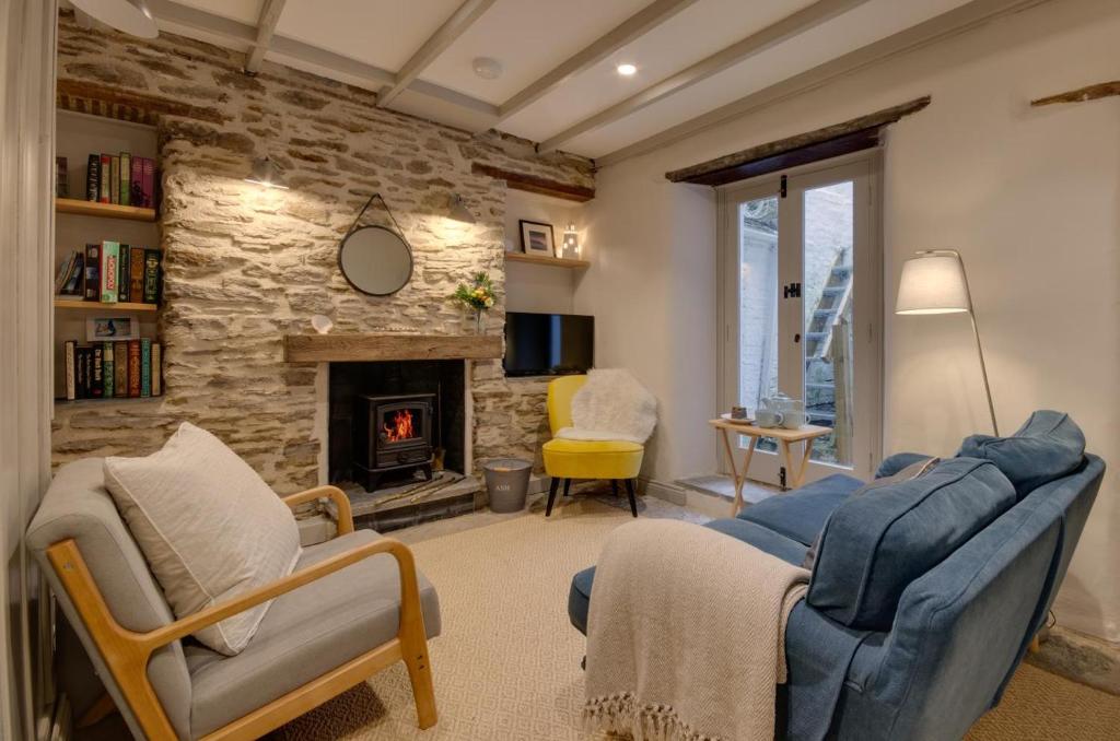 a living room with two chairs and a fireplace at 3 Bed in Fowey oc-p00871 in Fowey