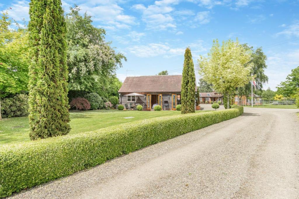 a house with a driveway and trees in front at 2 Bed in Little Hereford oc-l29580 in Berrington