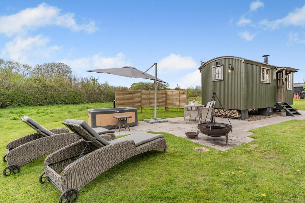 a backyard with a ping pong table and a tiny house at 1 Bed in Bronllys oc-t31949 in Bronllys