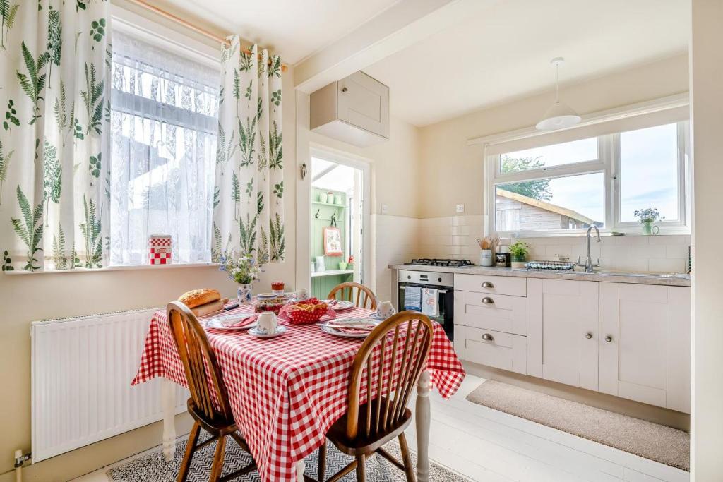 a kitchen with a table with a red and white table cloth at 2 Bed in Dymchurch oc-s31998 in Dymchurch