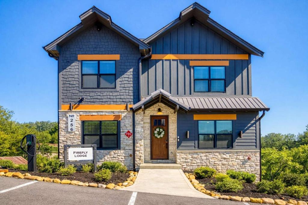 a house with a blue roof at Firefly Lodge - Pool, Theatre, Dog Friendly! in Pigeon Forge