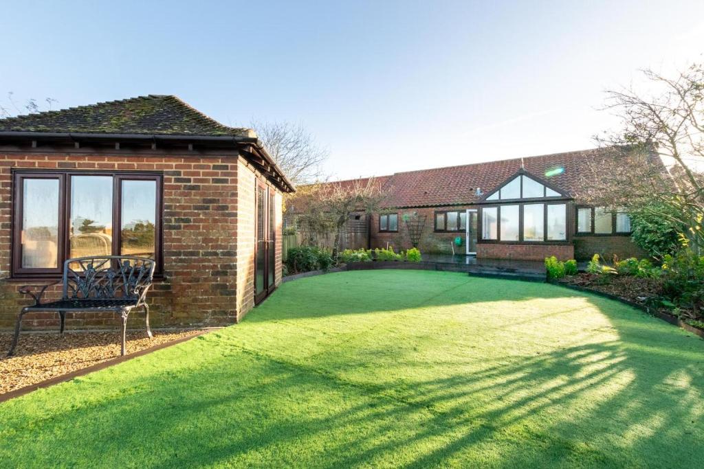 a house with a large lawn in front of it at 3 Bed in Thornham oc-m28084 in Thornham