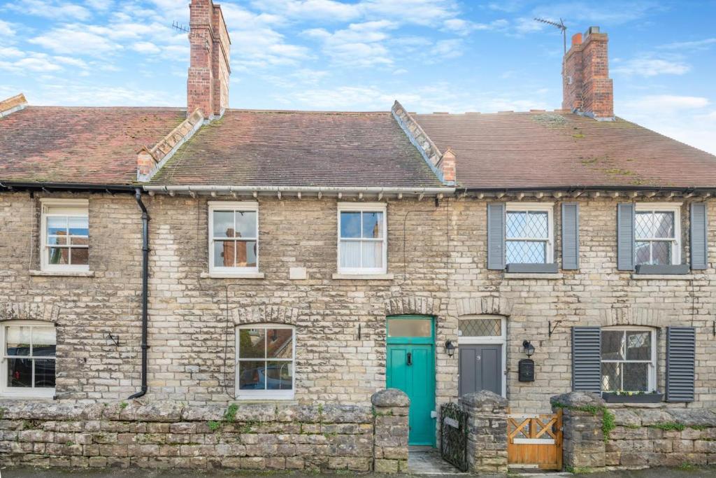 an old brick house with a green door at 3 Bed in Swanage oc-s30316 in Swanage