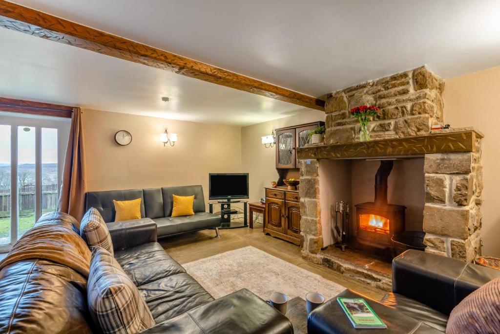 a living room with a couch and a stone fireplace at 2 Bed in Eggleston oc-l30452 in Middleton in Teesdale