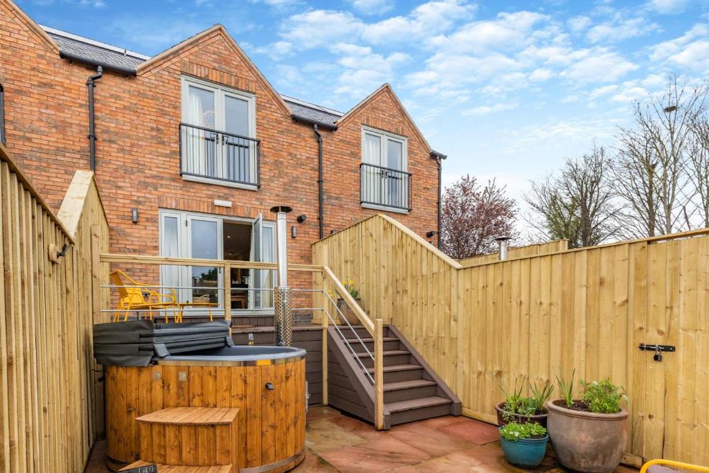 a house with a wooden fence and a hot tub at 1 Bed in Pershore oc-t29049 in Pershore