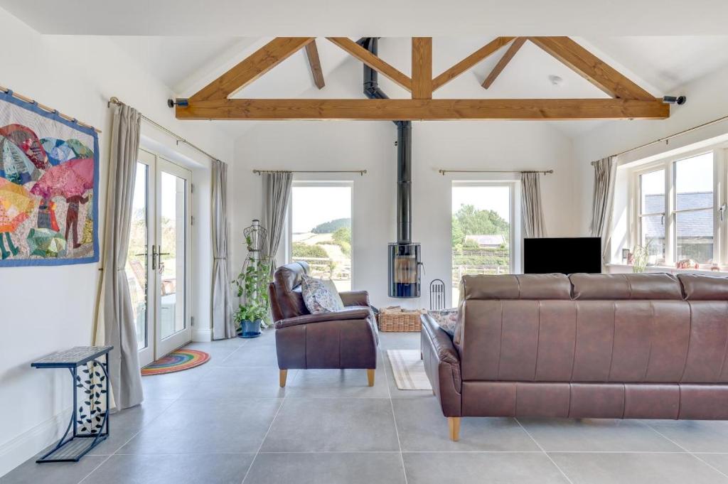 a living room with a brown couch and chairs at 3 Bed in Chatton oc-nb1987 in Chatton