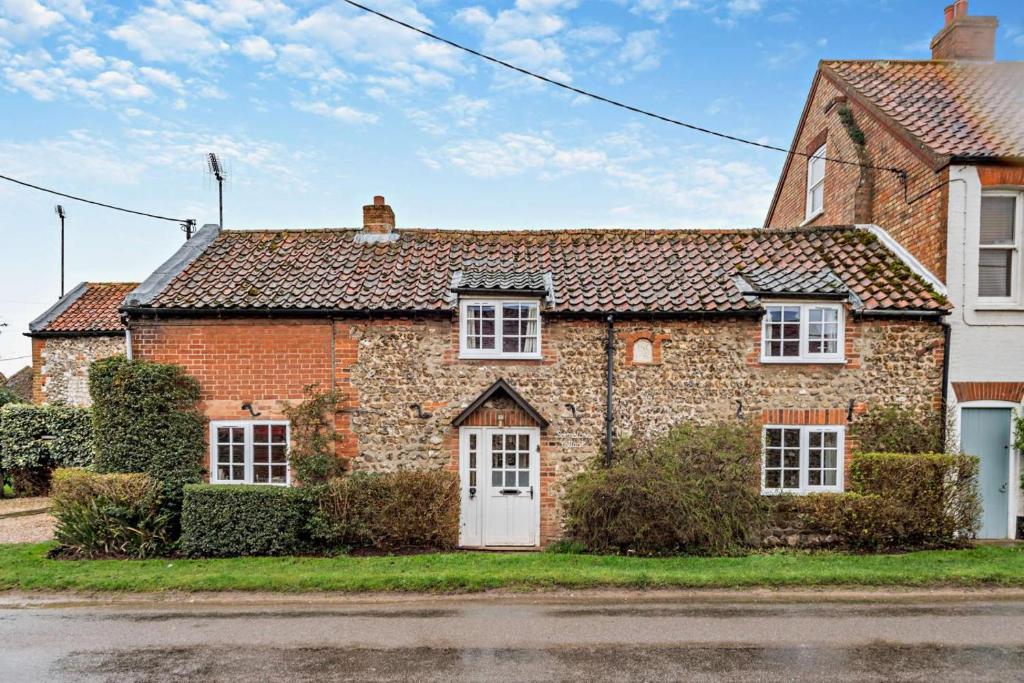 an old brick house with a white door at 2 Bed in Brancaster oc-b28394 in Brancaster