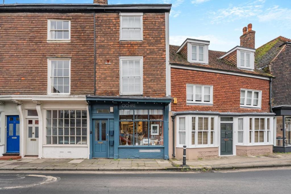 a brick building with a blue door on a street at 1 Bed in Lewes oc-n29713 in Lewes