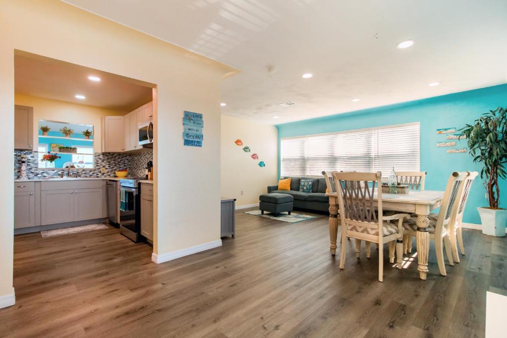 a kitchen and dining room with a table and chairs at Lovely vacation home 1 block from beach & downtown Gulfport in St. Petersburg