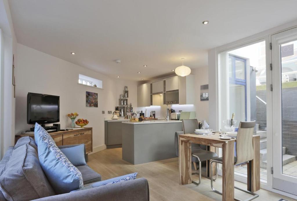 a living room and kitchen with a couch and a table at 2 Bed in Southwold oc-wtp in Southwold