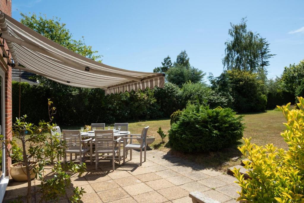 a patio with a table and chairs under a canopy at 3 Bed in Aldeburgh oc-10nw in Aldeburgh