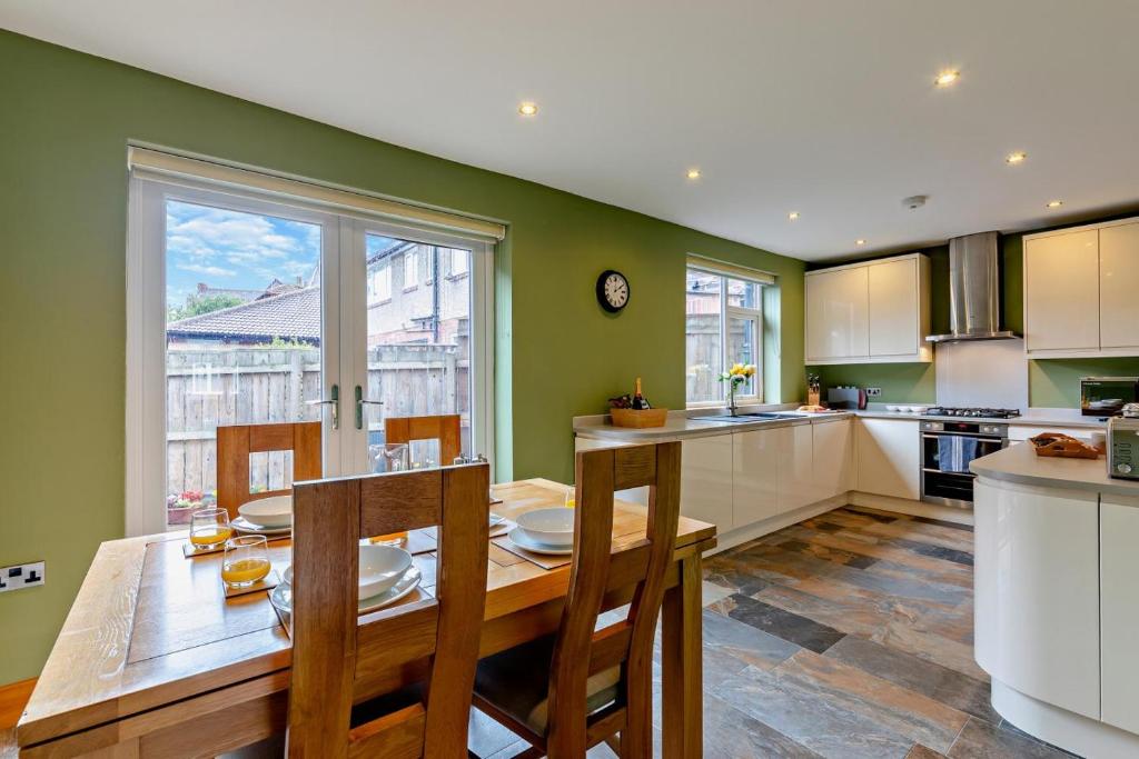a kitchen with a wooden table and a large window at 3 Bed in North Shields oc-b29939 in Tynemouth