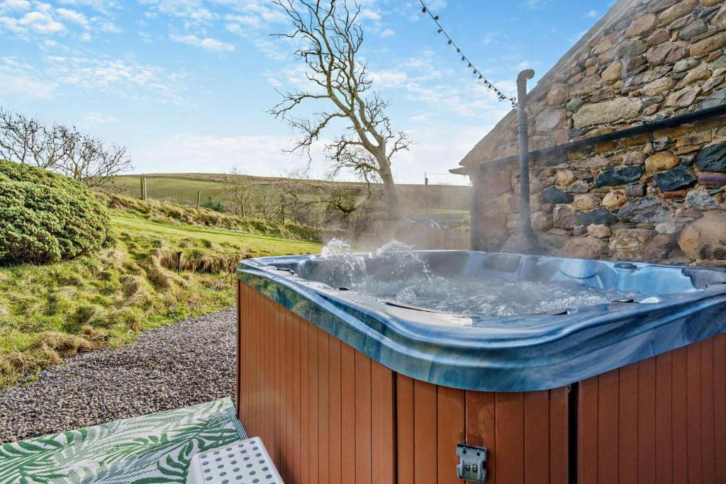a hot tub sitting outside of a building at 4 Bed in Kinniside oc-c28854 in Frizington