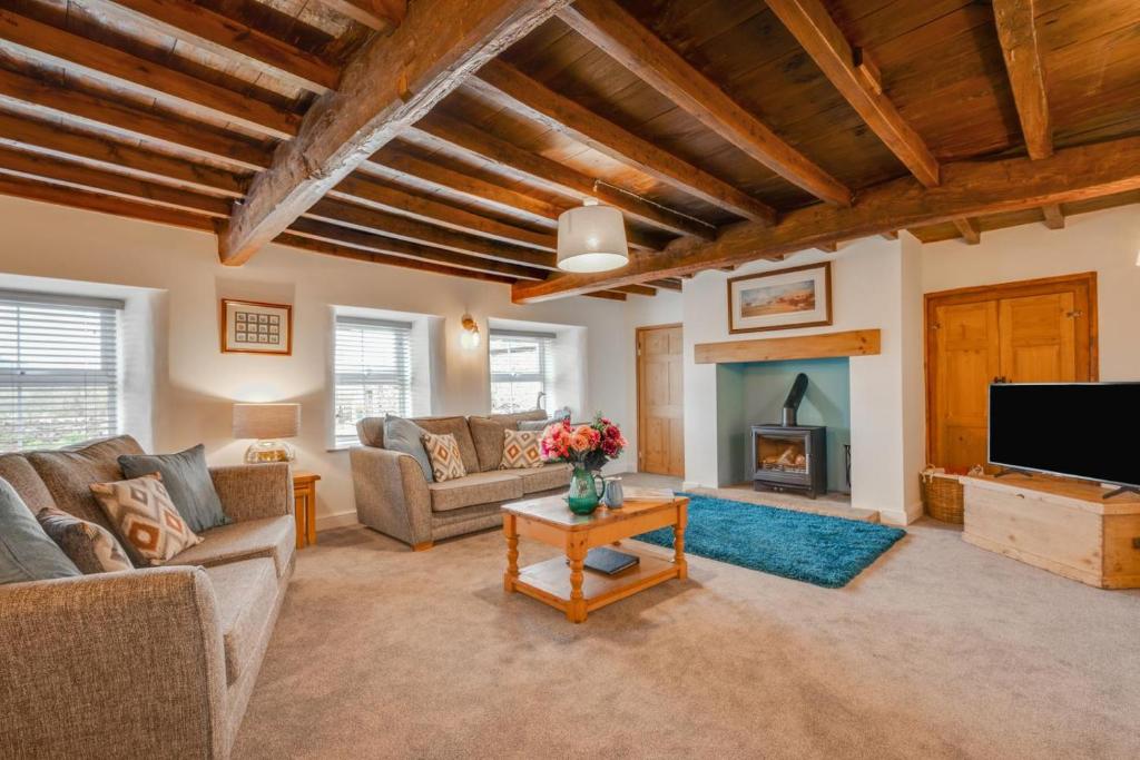 a living room with a couch and a fireplace at 3 Bed in Askrigg oc-ds1049 in Askrigg