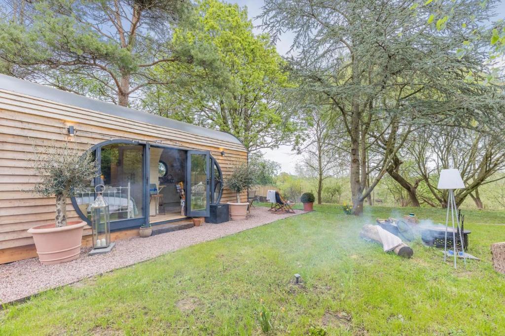a caravan in a yard with a fire in the grass at 1 Bed in Upton-upon-Severn oc-t30854 in Upton upon Severn
