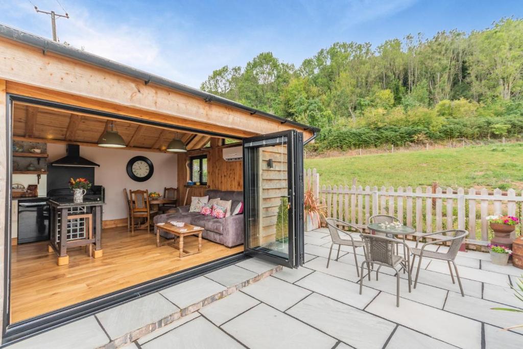 a patio with a couch and a table on a deck at 1 Bed in Whitbourne oc-s32935 in Whitbourne