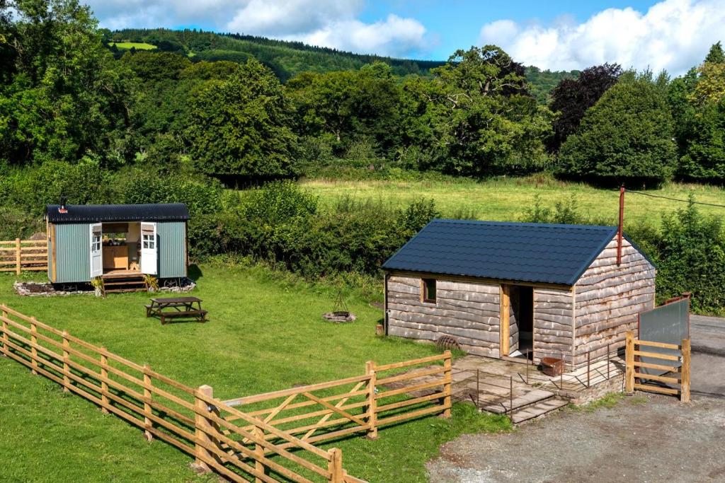 a small cabin in a field next to a fence at 1 Bed in Talybont-on-Usk oc-a29348 in Talybont