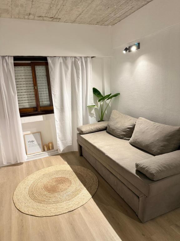 a living room with a couch and a rug at Portal al mar residence in San Bernardo