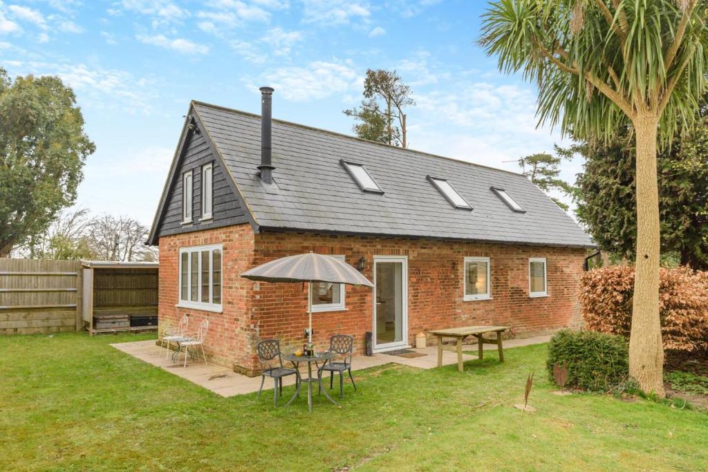 a brick house with an umbrella and a table at 2 Bed in Battle oc-c31781 in Battle