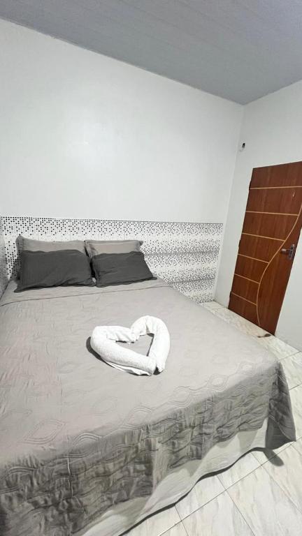 a white towel is laying on a bed at Ilka in Barreirinhas
