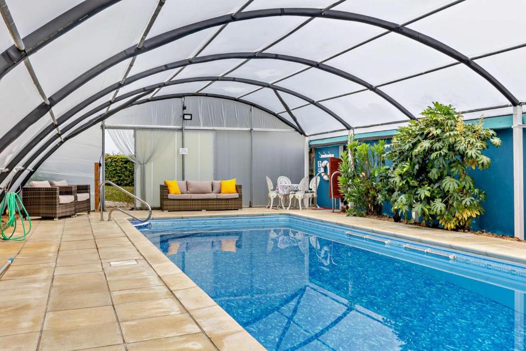 a swimming pool with a metal canopy over it at 4 Bed in Litcham oc-h30106 in Litcham