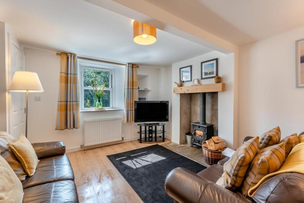 a living room with a leather couch and a fireplace at 3 Bed in Coldingham oc-b29846 in Coldingham