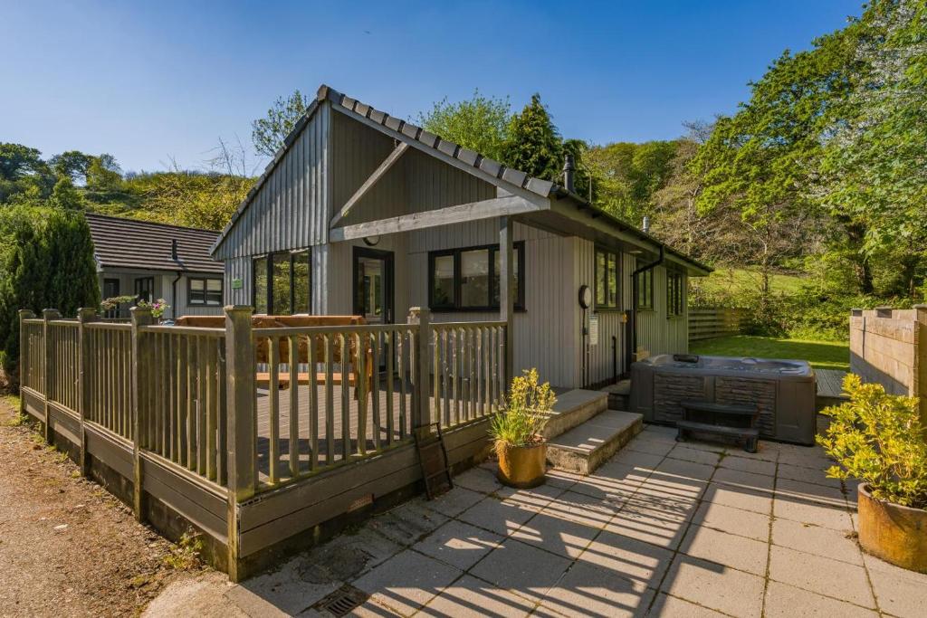 a small house with a wooden fence in the yard at 2 Bed in Bush oc-h31848 in Bude