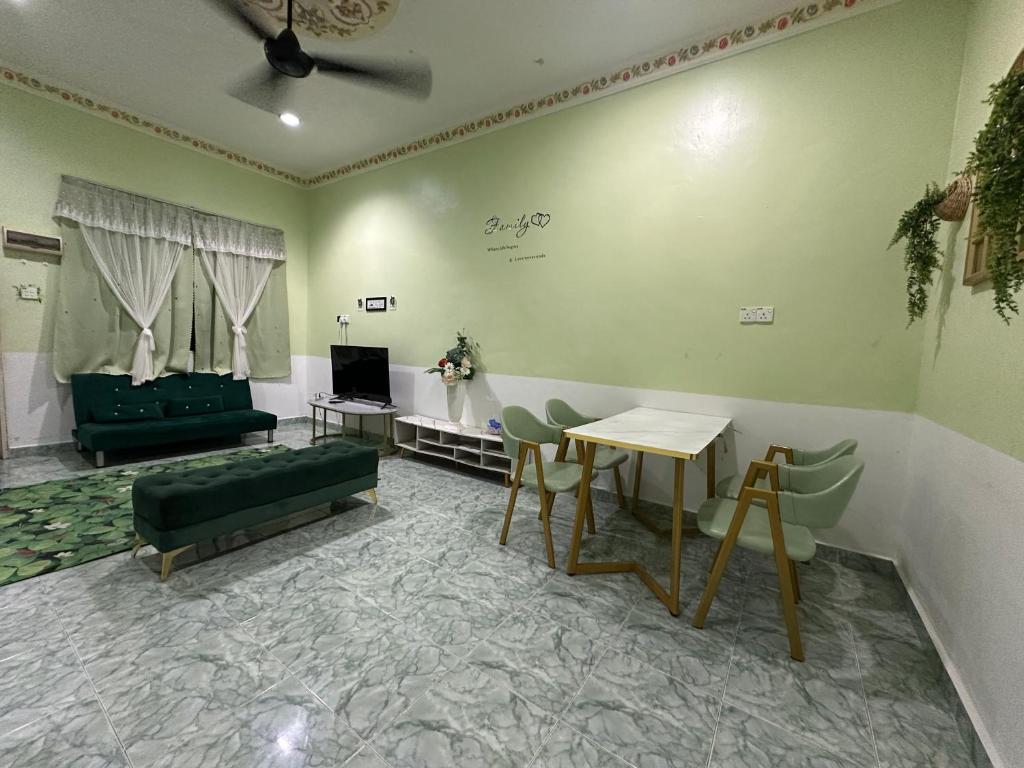 a living room with a couch and a table at Olive Cottage in Marang