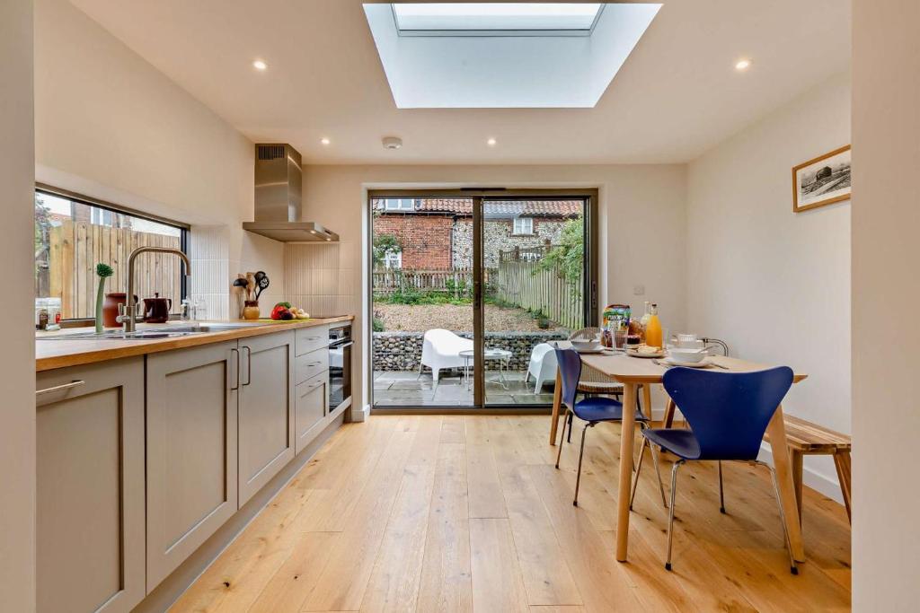 a kitchen with a table and chairs and a dining room at 1 Bed in Syderstone oc-c29233 in Syderstone