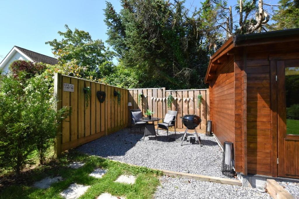 a backyard with a fence and a grill at 1 Bed in Cilycwm oc-t29297 in Cilycwm