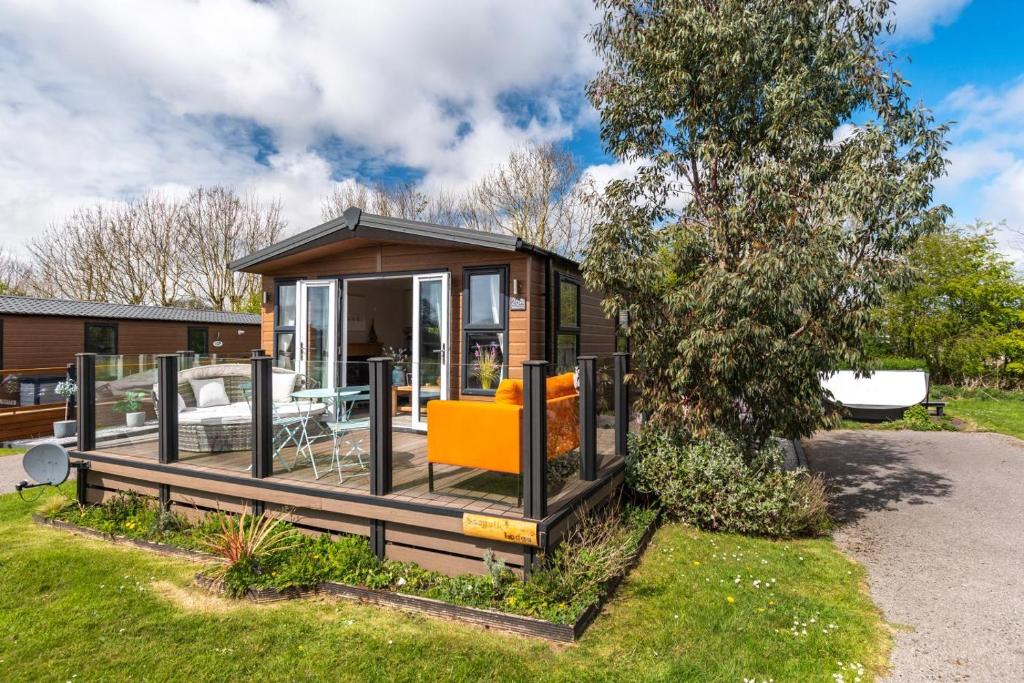 a tiny house in a garden with a porch at 2 Bed in Sewerby oc-s31941 in Sewerby