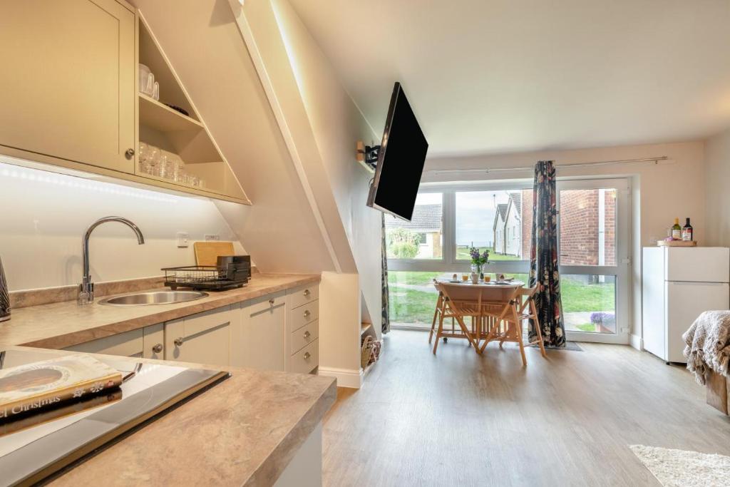 a kitchen with a sink and a table at 3 Bed in Corton oc-s32347 in Corton