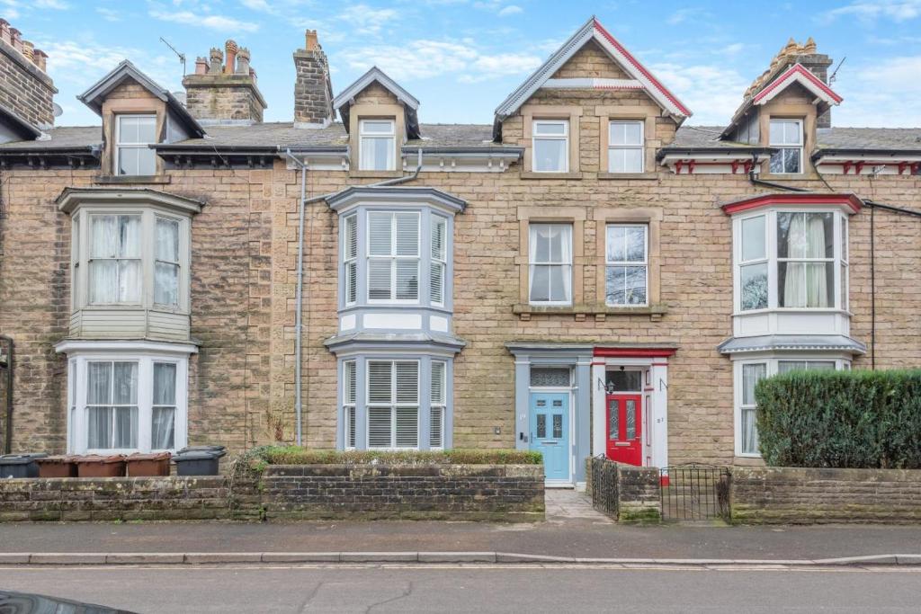 a large brick house with a red door at 6 Bed in Buxton oc-s31063 in Buxton