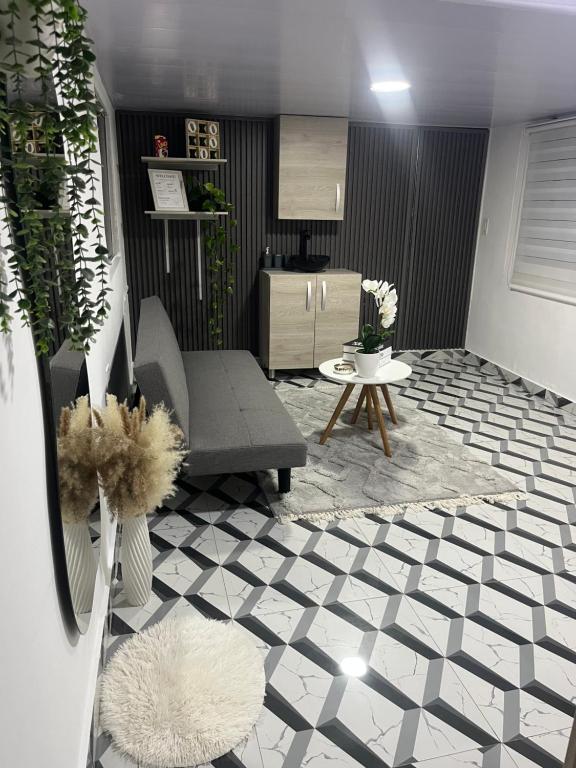 a living room with a couch and a table at Apartamento en Itagüí in Itagüí