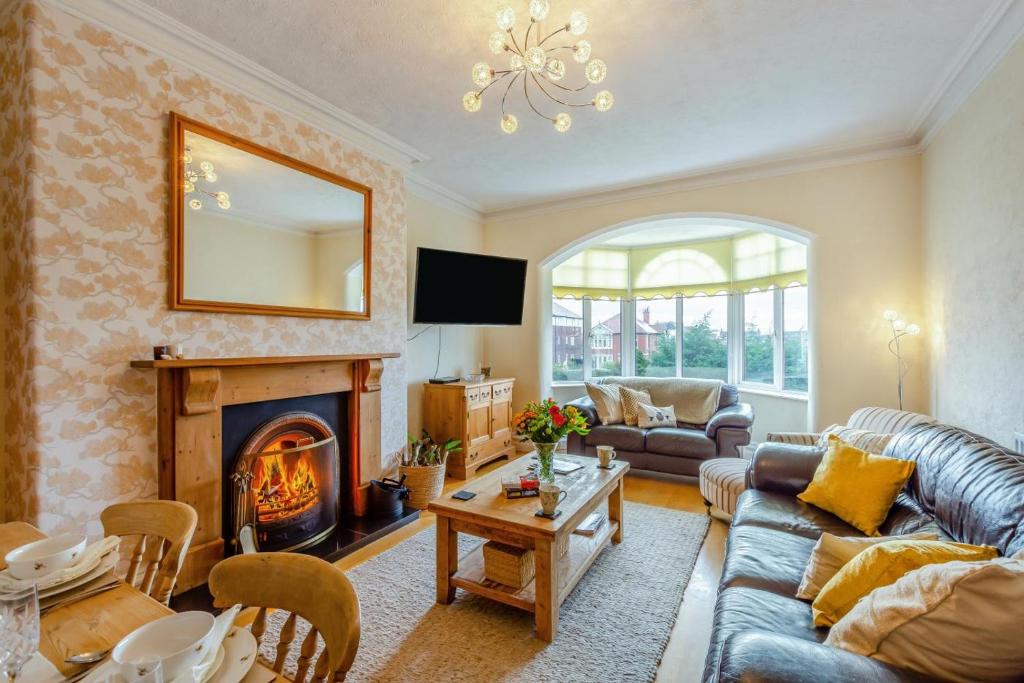 a living room with a couch and a fireplace at 3 Bed in Lytham St. Annes oc-m30622 in Saint Annes on the Sea