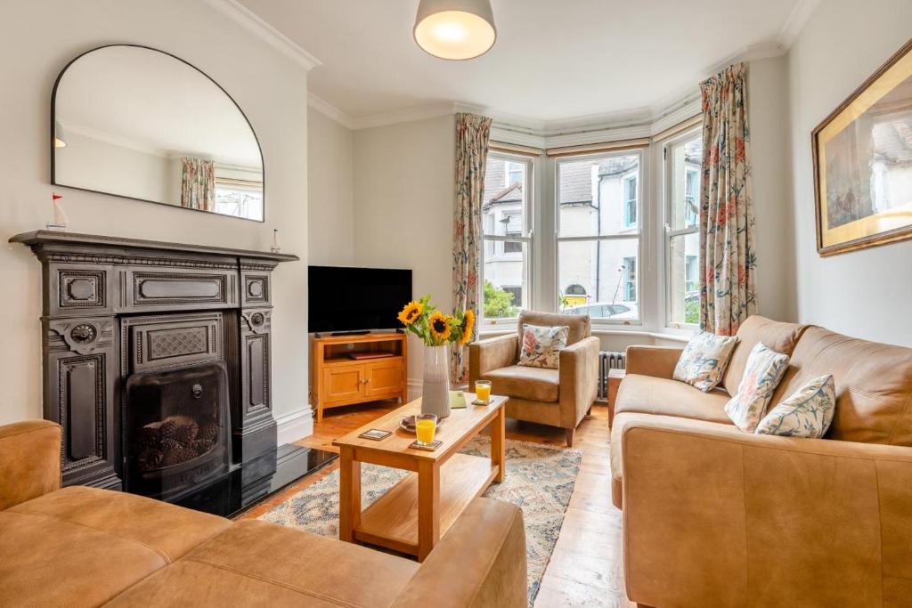 a living room with a fireplace and a couch at 4 Bed in Swanage oc-a29454 in Swanage